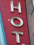 A sign that says "HOT". Either that, or it is a "HOTEL" sign that's been cropped. We just don't know.