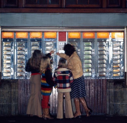 A family gathered around a series of vending machines