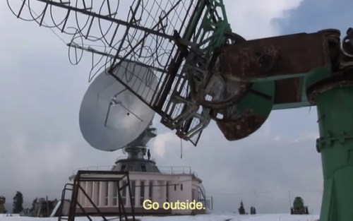satellites Film still from whiteonwhite - showing satellite dish in desolate landscape