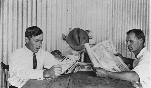 Men reading newspapers