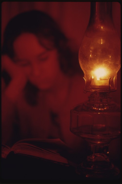 Woman eading by gaslight