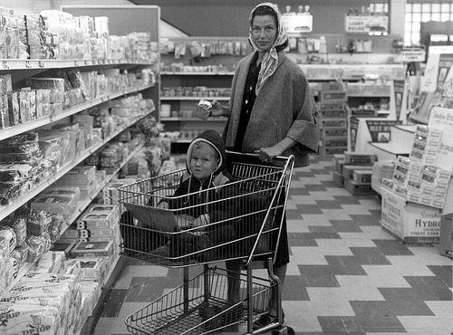Woman in supermarket, child in trolley