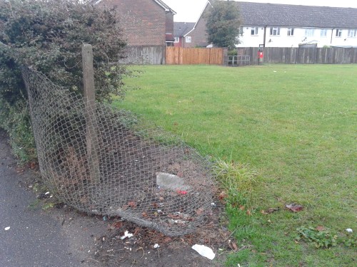 Broken fence into park