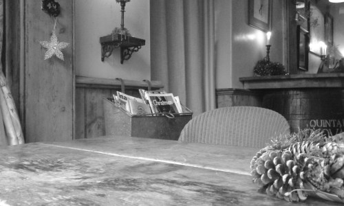 Empty table with Christmas decorations dotted about