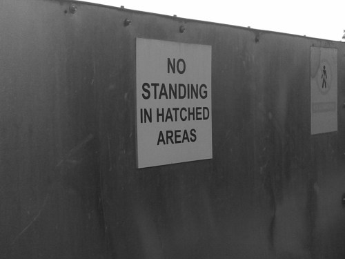 No standing in hatched areas sign