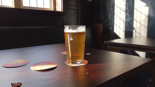 Beer glass on a pub table