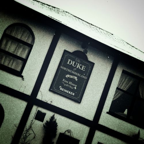 Close-up of a pub building, a sign in the middle for The Duke of Northumberland.