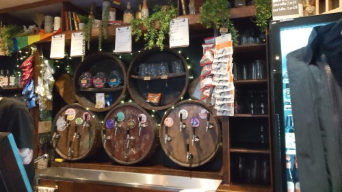 Interior of Barrel Drop, Nottingham. A view of the back bar, where old barrels have been converted to house various keg taps, to keep glasses and store snacks